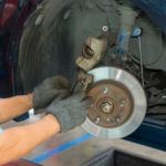 Man fixing brakes Man fixing brakes